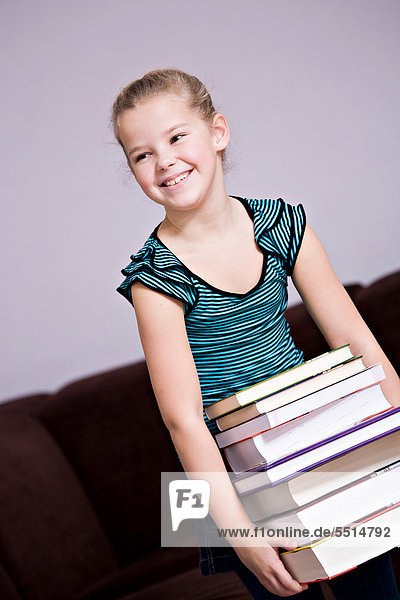 Girl  8  carrying a stack of books