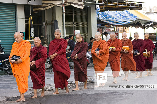 Monks on their way to beg for alms in Ho Chi Minh City  Saigon  Vietnam  Southeast Asia  Asia