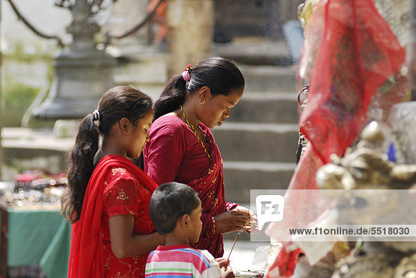 Praying women with child  Swayambhunath temple  Kathmandu  Nepal  Asia