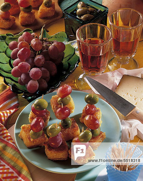 Spanish cheese skewers  diced manchego cheese battered with almonds and breadcrumbs  grapes  Spain  recipe available for a fee