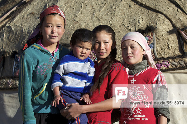 Three Kirghiz girls and a boy in front of a yurt in Murghab  Murgab  Pamir region  Tajikistan  Central Asia  Asia