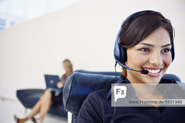 Smiling businesswoman wearing headset