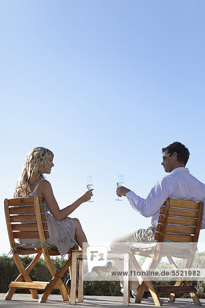 Smiling couple toasting each other
