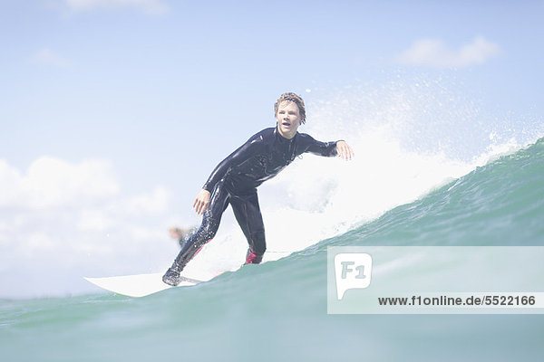 Teenage surfer riding a wave