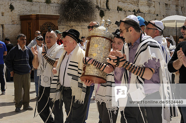 Bar Mitzvah celebration at the Western or Wailing Wall in the direction of the Jewish Quarter  boy is carrying the Torah scroll with the help of his father  Muslim Quarter  Old City  Jerusalem  Israel  Middle East