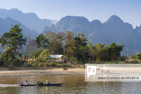 Herd of buffaloes and canoe on the Nam Song River  karst mountains  Vang Vieng  Vientiane  Laos  Indochina  Asia