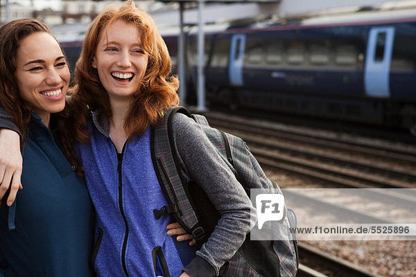 Young women smiling at train station