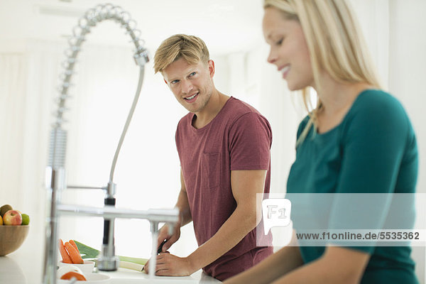 Couple working together in kitchen