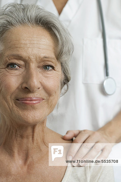 Senior woman with caring doctor  cropped