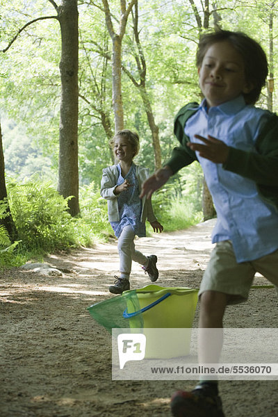 Children running in woods