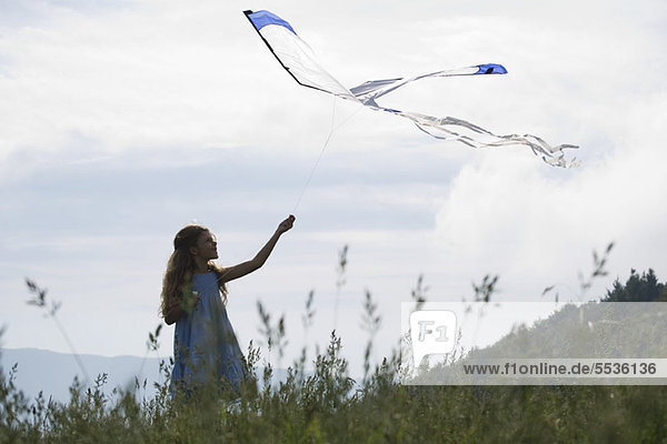 Girl flying kite