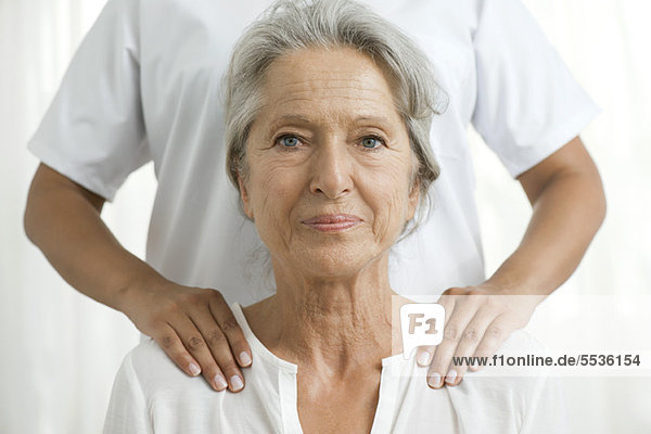 Senior woman getting a shoulder massage