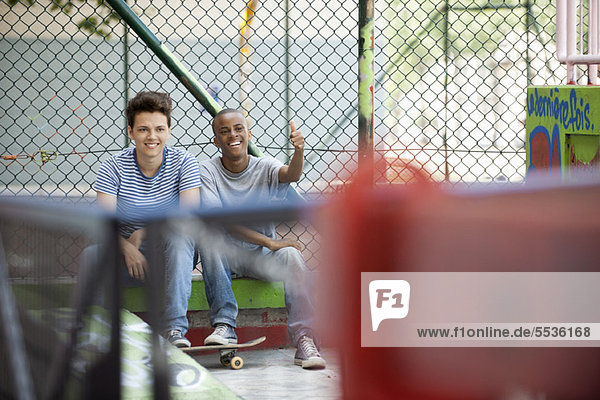 Young men hanging out in skateboard park
