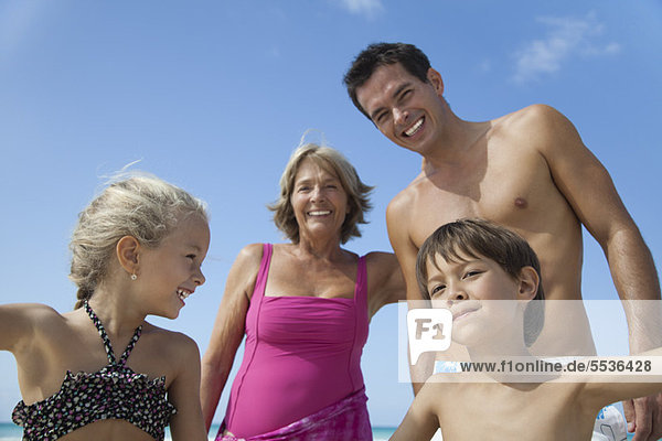 Multi-generation family having fun at the beach