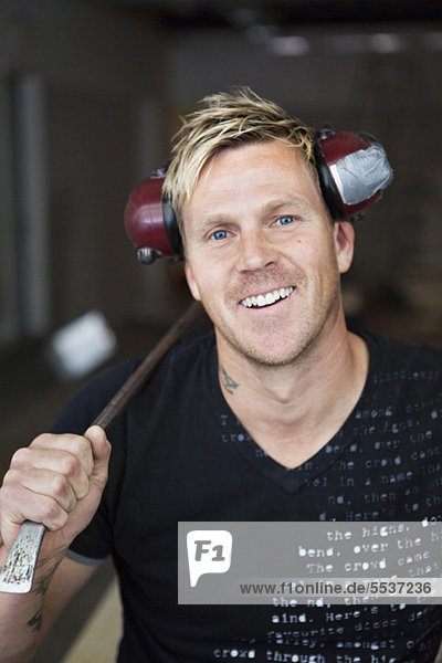 Portrait of cheerful carpenter with ear protectors