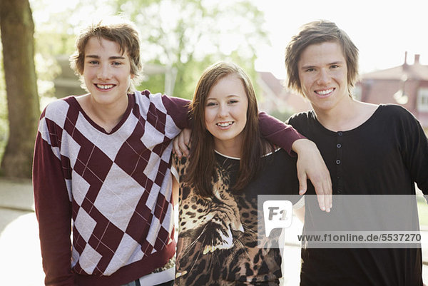 Portrait of teenage friends smiling together outdoors
