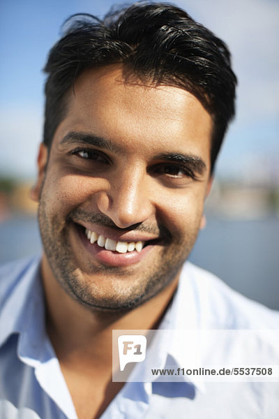Close-up portrait of cheerful young man