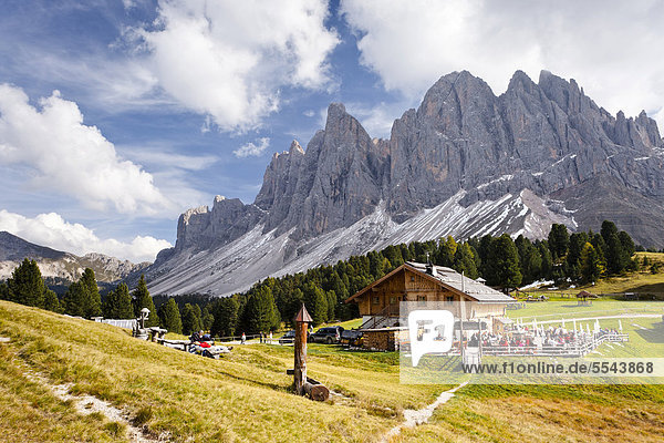 Hikers near the Geisleralm alpine pasture in the Valle di Funes below the Odle Mountains  Sass Rigais  Dolomites  Alto Adige  Italy  Europe