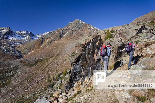 Hikers during the ascent to Hinterer Eggenspitz Mountain in the Val d'Ultimo above Weissbrunnsee Lake  Alto Adige  Italy  Europe