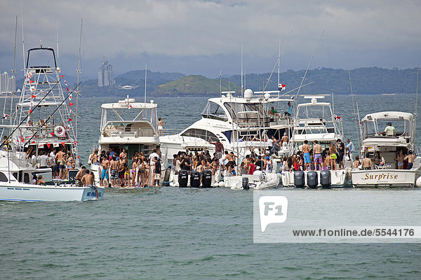 Young people from Panama City celebrating a weekend party on yachts on the island of Isla Taboga  Panama  Central America