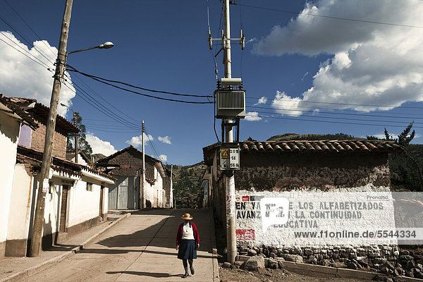 Village street with advertising for a literacy campaign on a house wall  Yaurisque  Peru  South America