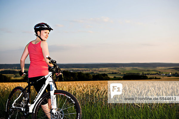 Female cyclist in rural landscape