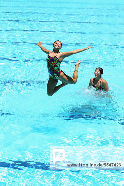 Swimmers Performing  Synchronized Swimming