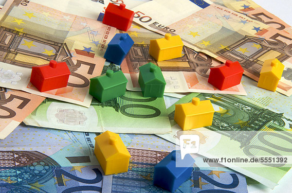 Miniature houses on euro notes  symbolic image real estate