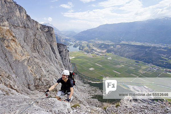 Climber climbing the Che Guevara climbing route on Monte Casale in Sarca Valley  Lake Garda area  overlooking Lake Toblino  Trento  Italy  Europe