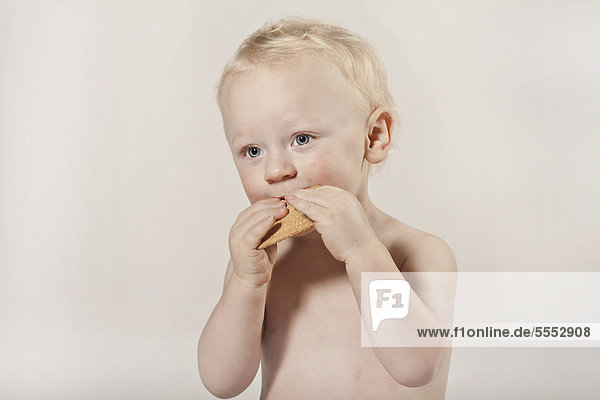 Kleinkind  Junge  1 Jahr  isst einen Keks