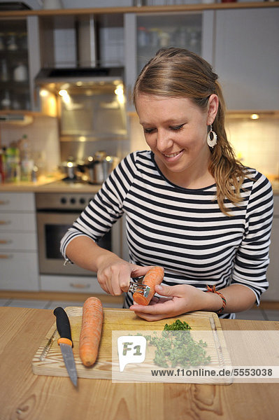 Young woman cutting vegetables in a kitchen