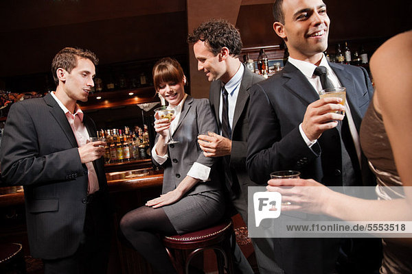 Colleagues drinking together in bar