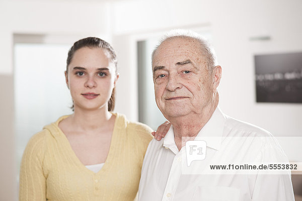 Smiling young woman and senior man  portrait