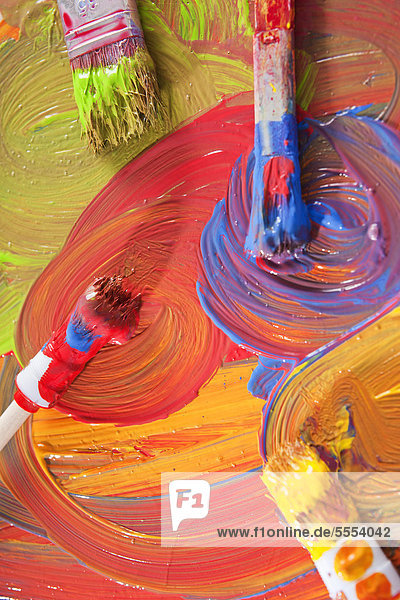 Paint brushes and colorful paints