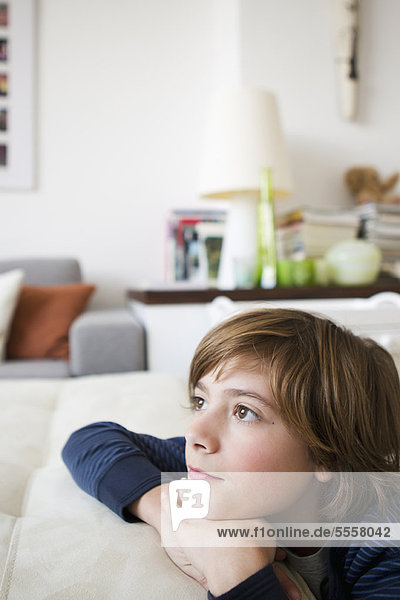 Boy relaxing on sofa in living room