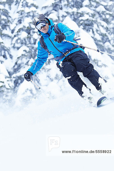 Skier coasting down snowy slope