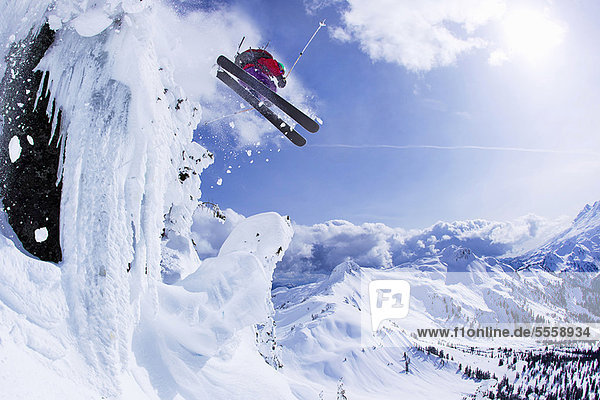 Skier jumping snowy slope
