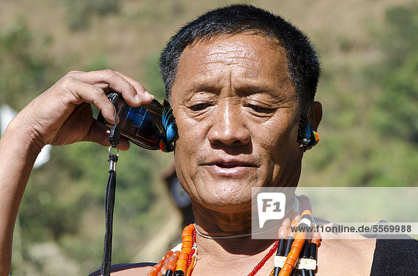 Headhunter using a mobile phone  Kohima  Nagaland  India  Asia