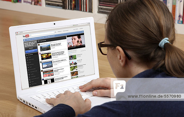 Frau am Laptop surft im Internet  YouTube  Filme ansehen  hochladen