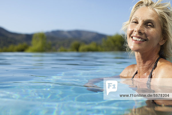 Mature woman relaxing in pool  portrait