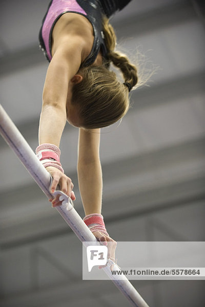 Female gymnast on horizontal bar