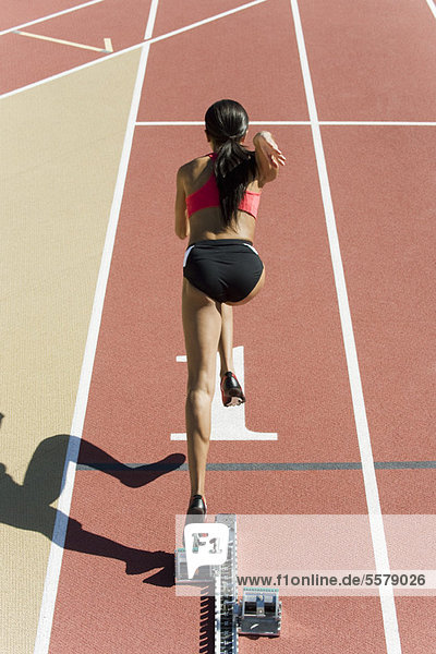 Female runner at starting line  rear view