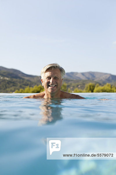 Senior man relaxing in pool  portrait