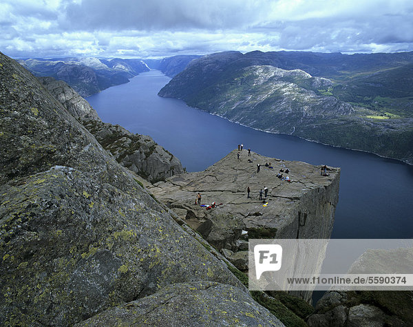 Preikestolen  Preacher's Pulpit or Pulpit Rock  with tourists  at Lysefjorden or Lysefjord  Rogaland  Norway  Scandinavia  Europe