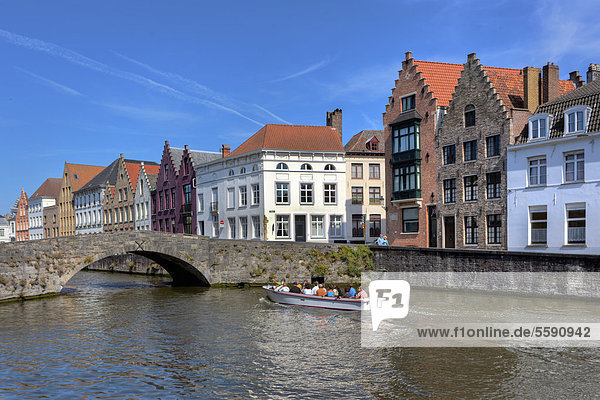 Old houses and a tourist boat on Lange Rei Canal  Bruges  West Flanders  Flemish Region  Belgium  Europe