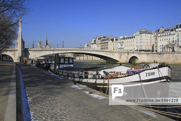 Seine river with the bridge Pont La Tournelle and a cargo ship  Notre-Dame  Paris  France  Europe