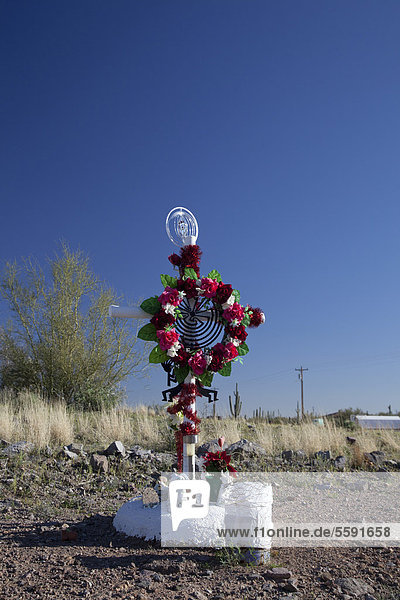 A shrine at the side of a road on the Tohono O'odham Reservation marks the site of a fatal auto accident  Sells  Arizona  USA