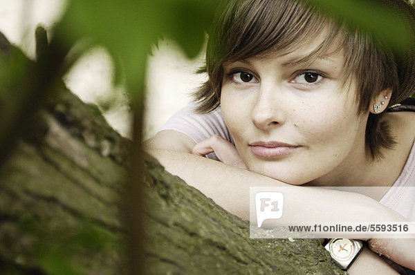 Young woman lying on branch  portrait