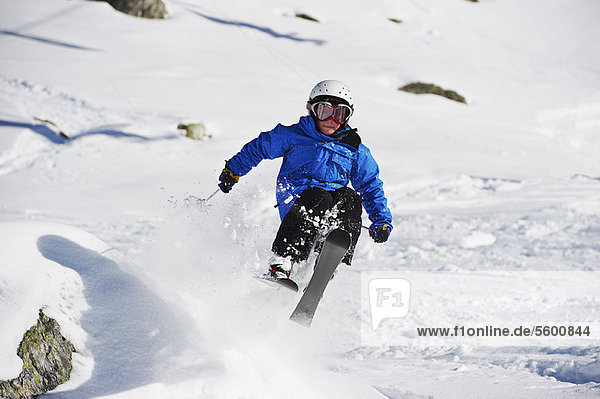 Boy skiing on snowy mountainside