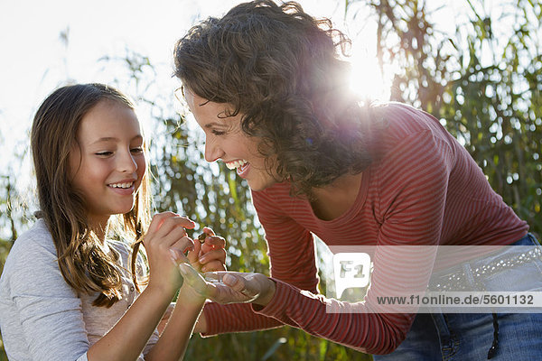 Mother and daughter talking outdoors